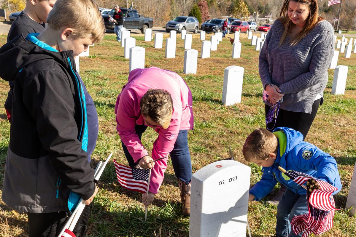 Paying respect: Volunteers place flags at Veteran’s cemetery