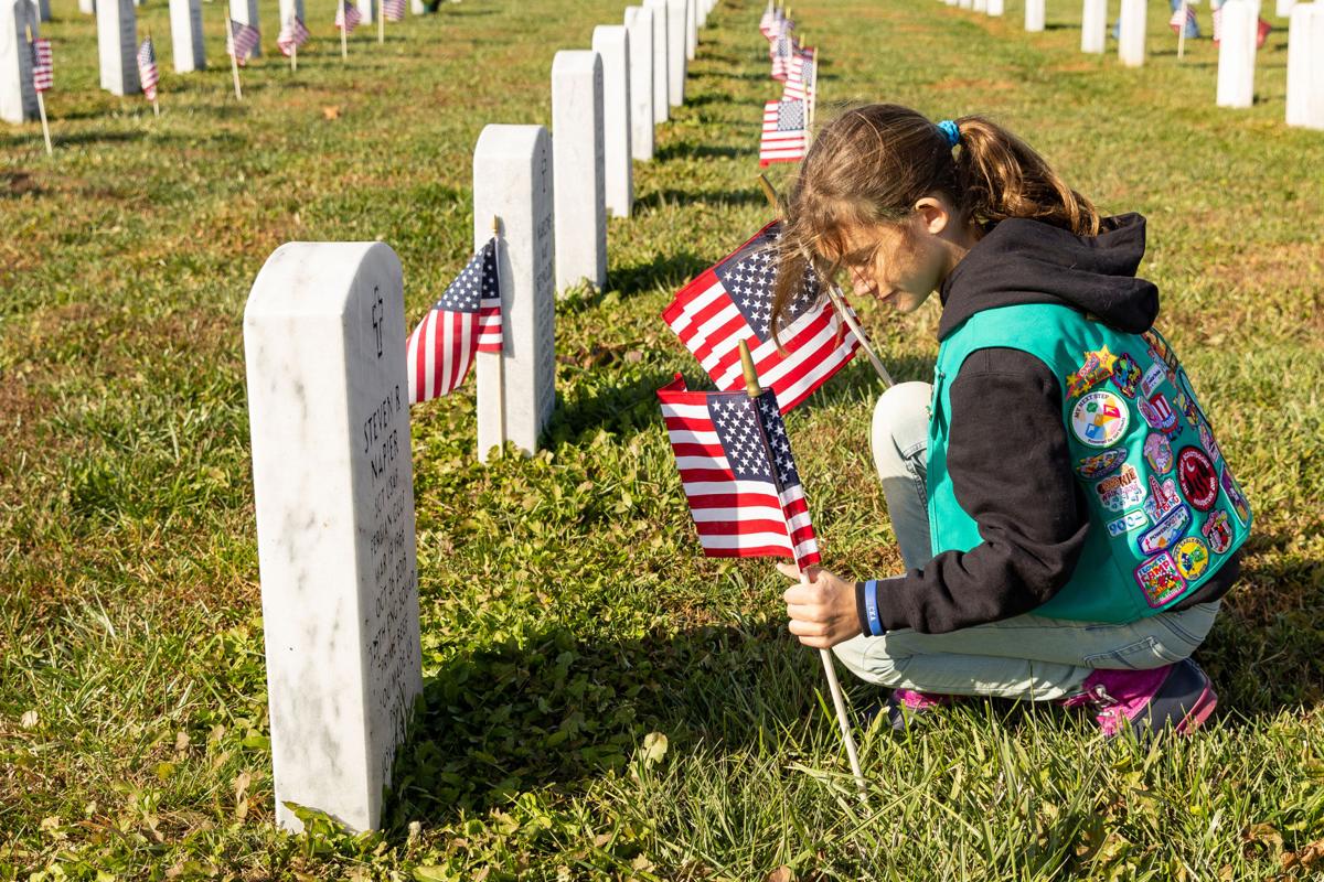 Paying respect: Volunteers place flags at Veteran’s cemetery