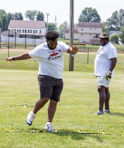 NFL players share their knowledge with youngsters during camp in