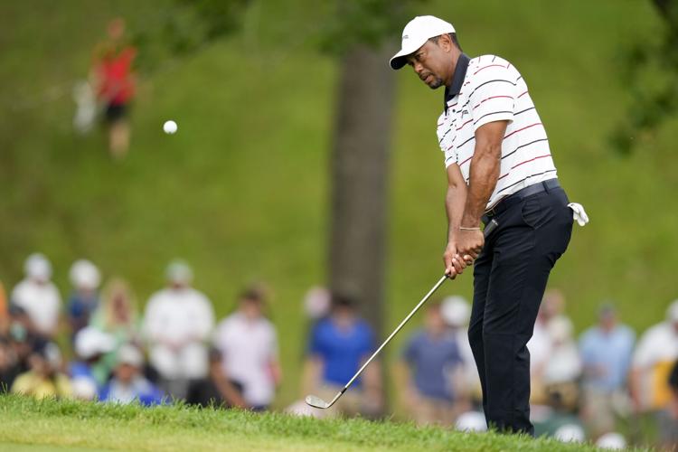 Woods gets stuck in sand, makes two early triples en route to a 77 and