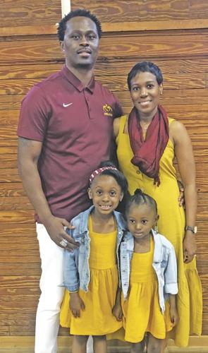 Brandon Isaac with his wife and daughters at his going away celebration.