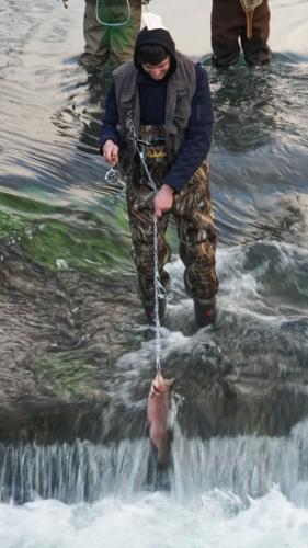 Angler reeling in a catch in the first hour of fishing opening day at Montauk State Park.