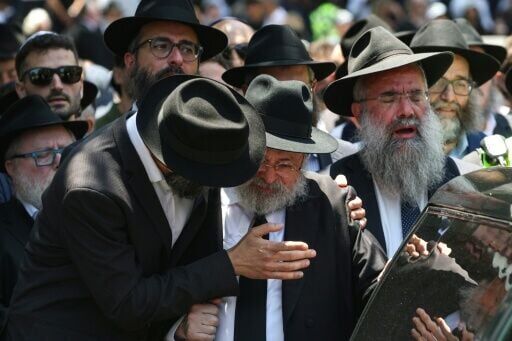 Mourners follow the hearse carrying the coffin of rabbi Eli Schlanger, who was killed in the December 14 Bondi beach shooting attack, after his funeral service at the Chabad of Bondi Synagogue in Sydney on December 17, 2025