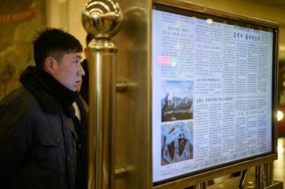 A man reads North Korea's Rodong Sinmun newspaper on a digital monitor at a metro station in Pyongyang