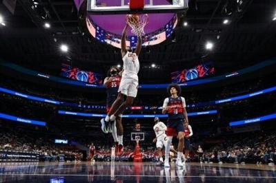 Cleveland's Evan Mobley, dunking the ball over Washington's Marvin Bagley III, will miss the next two to four weeks with a left calf strain, the NBA club announced
