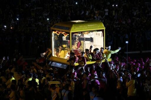 Philippine Catholic devotees crowd the carriage holding the image of Jesus Nazarene