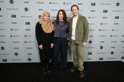 Syrian refugee Isra’a (L) stands alongside directors Itab Azzam and Jack MacInnes at the "One In A Million" premiere during the 2026 Sundance Film Festival
