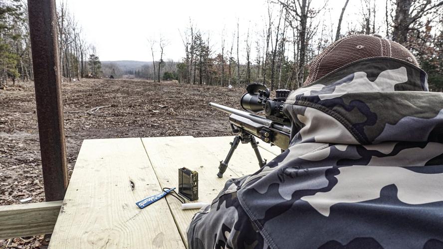 Caleb Gidcumb firing his rifle from the prone position.