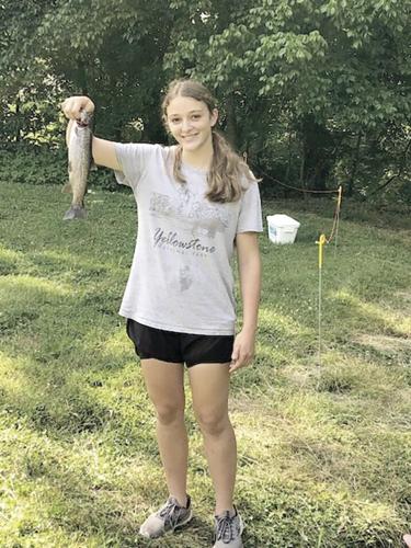 Dent County 4-H'er Neva Trosper catches a rainbow trout.