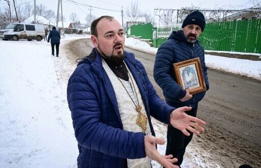 Priest Sebastian Resetnic, left, doubts whether Russia had anything to do with the drones