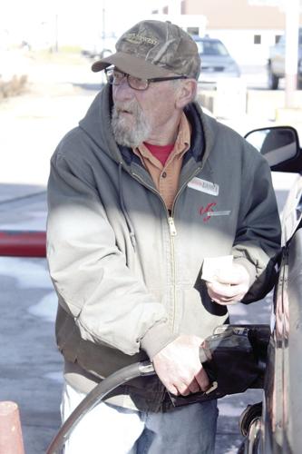 Larry Dallas pumping gas at Phil-Mart during his shift.