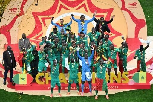 Senegal players celebrate with the trophy after beating hosts Morocco in the final to win the Africa Cup of Nations for the second time in their history