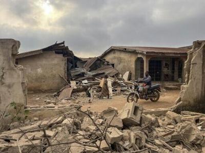 Debris damaged buildings in Offa, pictured here on December 27 two days after the strikes, where a hotel owner said people were injured