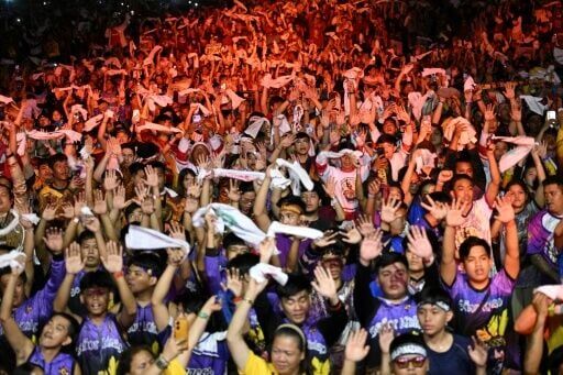 Philippine Catholic devotees wave white towels and handkerchiefs during mass prior to the annual religious procession of the image of Jesus Nazareno, also known as Jesus the Nazarene, in Manila on January 9, 2026
