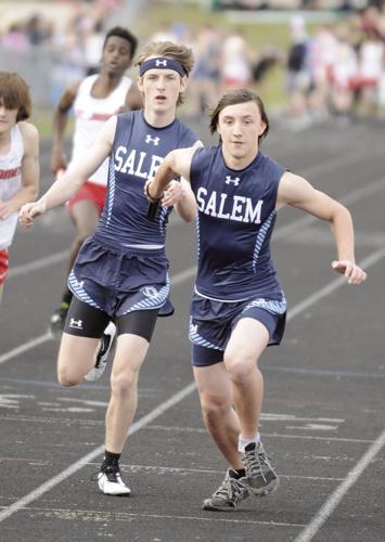 Senior Tyler Hancock handing off the baton to freshman Jacob Bender