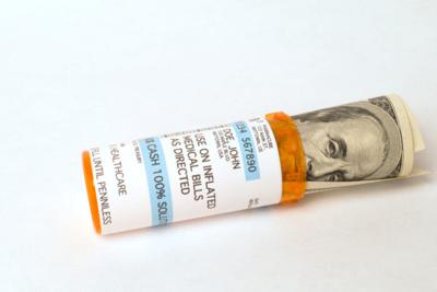 Hundred dollar bill in pill jar representing health care cost