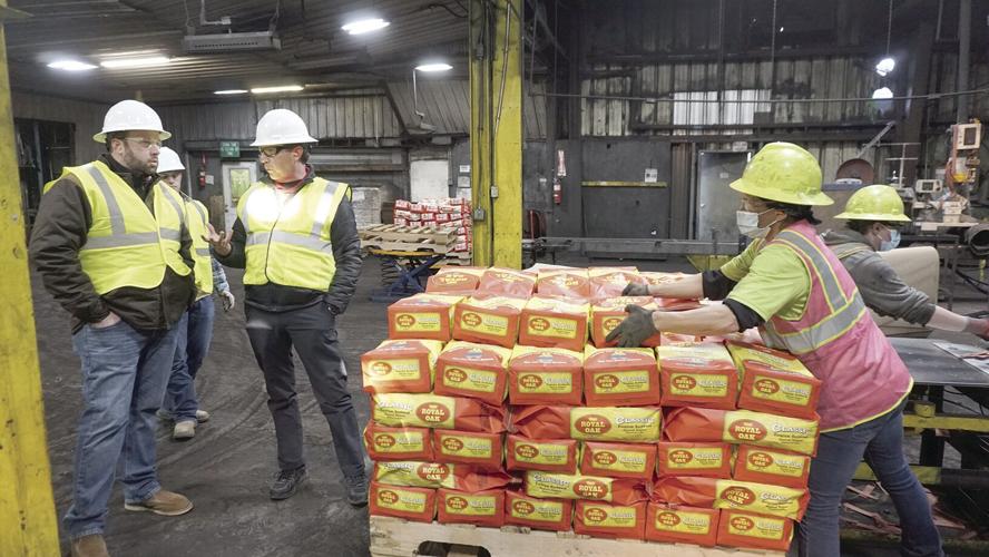 COO Randy Beech showing Cong. Smith the bagging line at Royal Oak