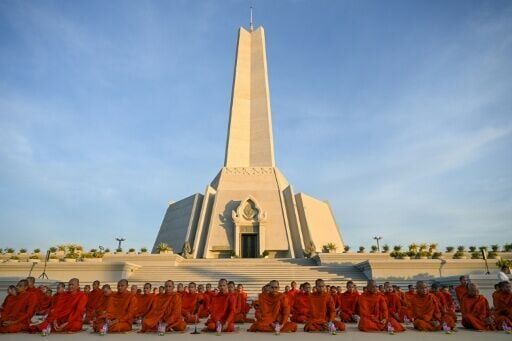 Cambodian Buddhist monks participate in a prayer for peace at the Win-Win monument