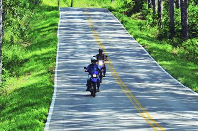Two motorcyclists ride down Highway 19