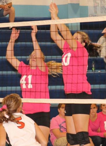 Kayla Hemken and Lydia Curley go up at the net