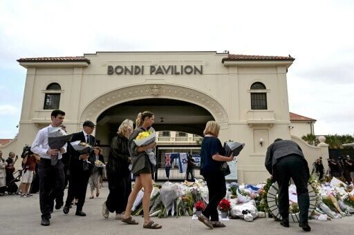 Mourners lay flowers at Bondi Pavilion after two gunmen killed 15 people in an attack on a Jewish festival at the world-famous beach