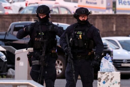 Armed police work at the scene after a shooting incident at Bondi Beach in Sydney