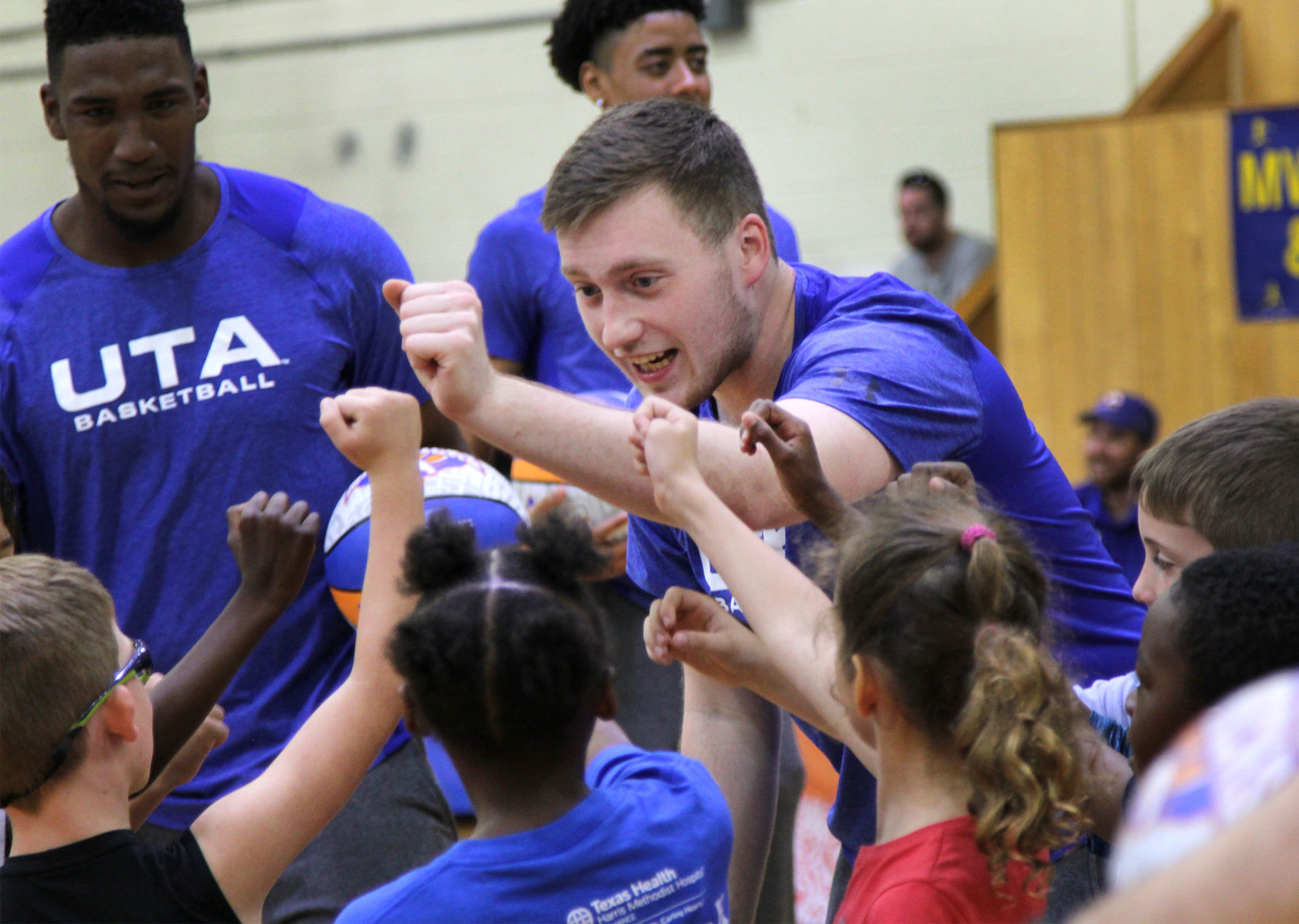 UTA players teach children to play during Hoops for Troops basketball camp