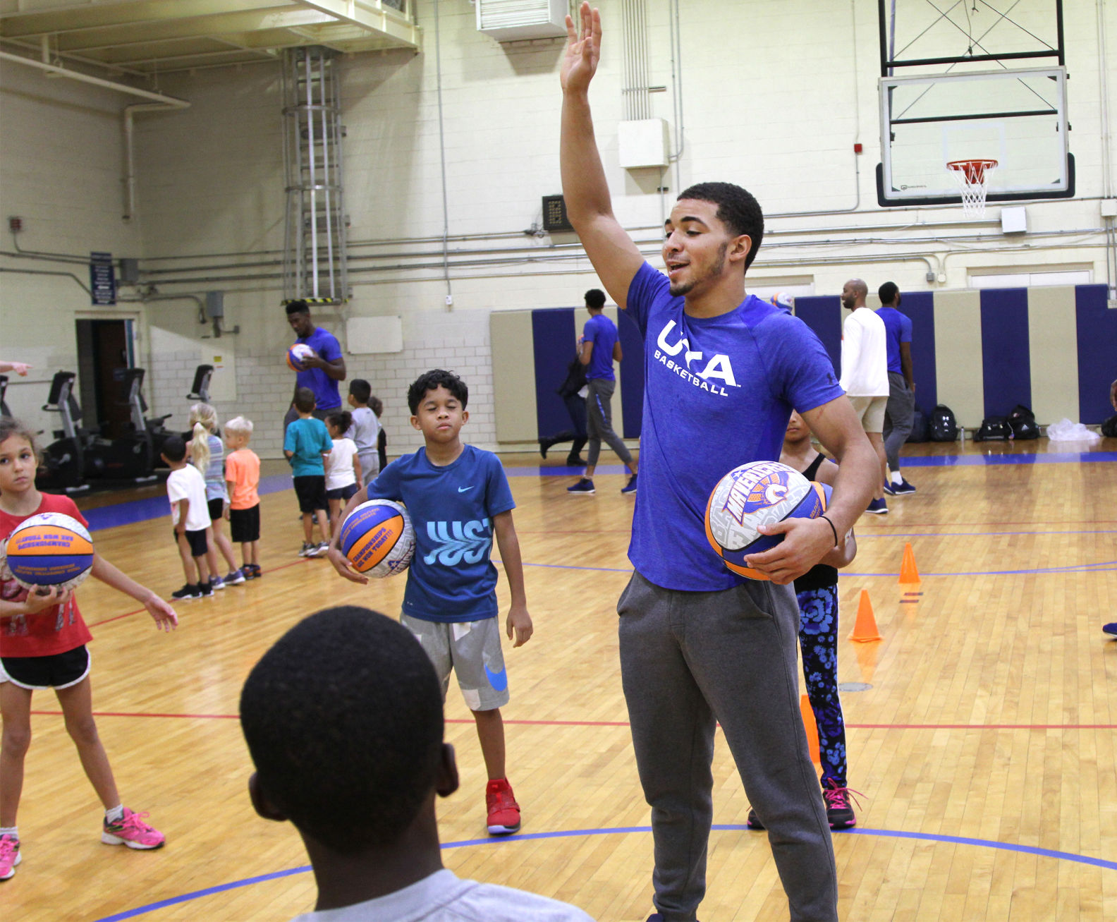 UTA players teach children to play during Hoops for Troops basketball camp