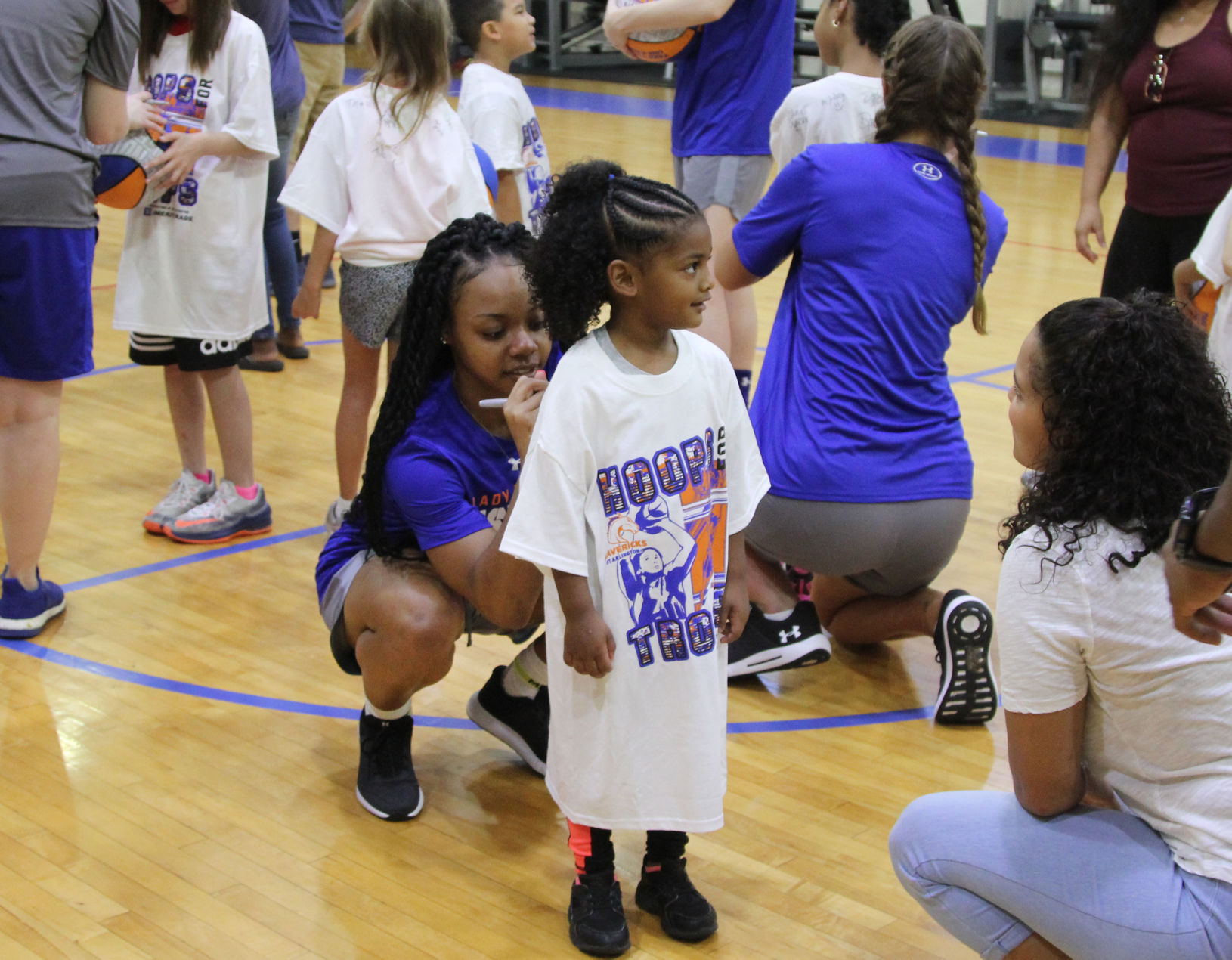 UTA players teach children to play during Hoops for Troops basketball camp