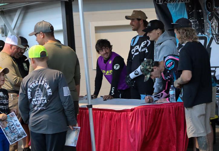 Motocross daredevils fly over the fair, defying gravity and feeling no ...