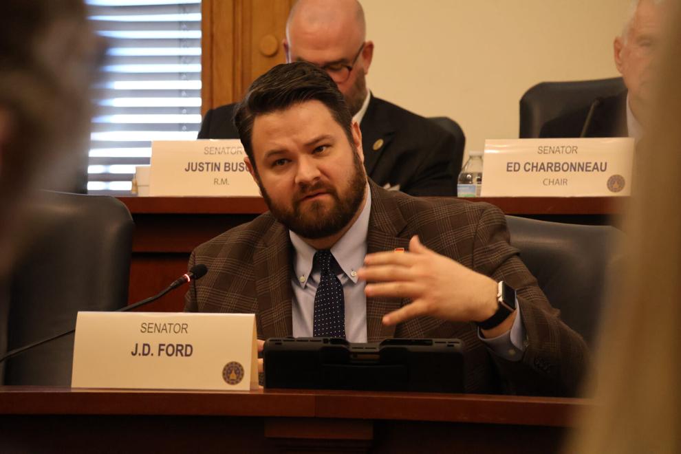 Sen. J.D. Ford, D-Indianapolis, speaks with Christopher Daniels, who represented the Indiana Prosecuting Attorney's Council, about Daniels' opposition of Senate Bill 91 on Wednesday.

Photo by Arianna Hunt, TheStatehouseFile.com.