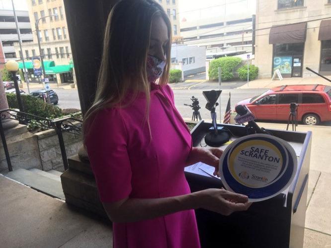 Scranton Mayor Paige Gebhardt Cognetti holds a "Safe Scranton" decal during a press conference on the steps of City Hall. JEFF HORVATH/STAFF PHOTO