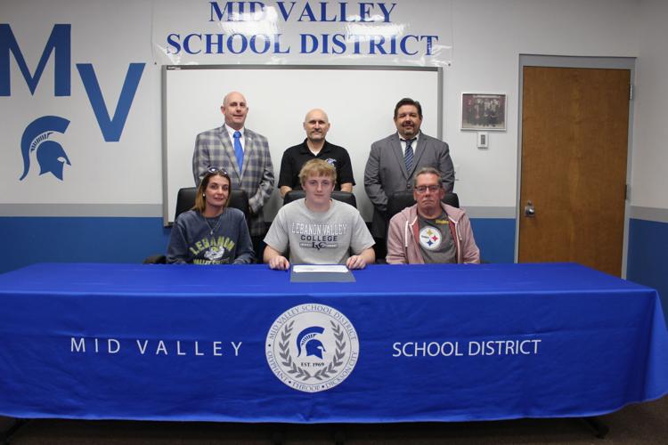 Mid Valley's Aiden Wolak has decided to continue his academic career, signing to play football at Lebanon Valley College. Seated from left: mother Amy Wolak, Aiden Wolak and grandfather Andrew Wolak. Standing from left: Athletic Director Tom Nowakowski,...