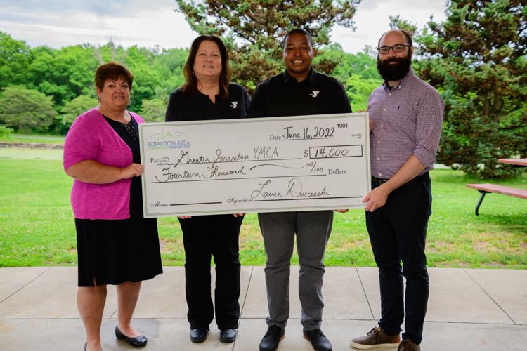 From left, Cathy Fitzpatrick, grants and scholarship manager at Scranton Area Community Foundation; Trish Fisher, president and CEO of Greater Scranton YMCA; Ken Brewster, aquatics director at the Greater Scranton YMCA and Frank Caputo, grants and commu...