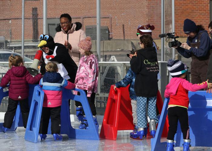 United Theatre Executive Director Carly Callahan (penguin costume) hands out prizes to waiting children while Mystic Aquarium Director of Philanthropy Lydia Shell looks during the Mystic Aquarium and United Theatre sponsored Penguins On Ice, a fun fille...