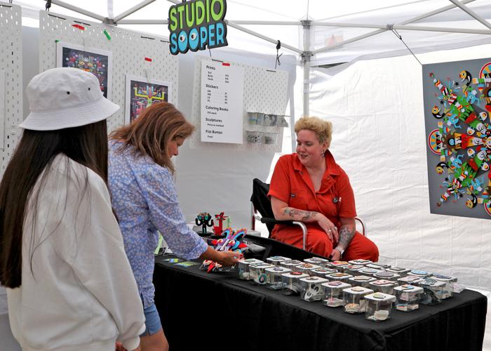 “Studio Sooper” owner Sarah Kuehnle (right), an artist, designer, and creative Technologist, chats with visitors looking over her work during the Fourth Annual Stonington Borough Merchants Association Art Walk held Saturday, September 17, 2022 in Stonin...