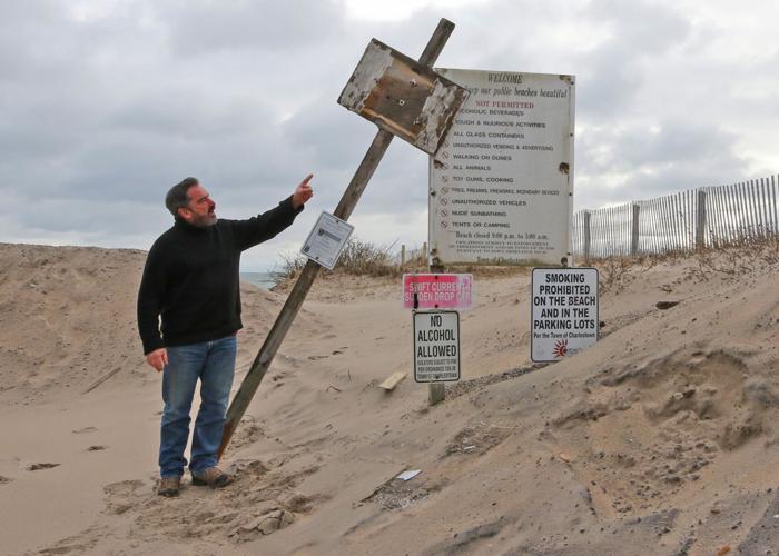 Charlestown resident Scott Keeley, standing at one of many Town Beach access points on Saturday afternoon, March 4, 2023, references an older sign once listing sections of the Rhode Island Constitution stipulating the rights of the people to access, use...