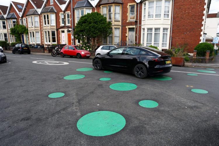 Mystery green spots on road leave residents baffled