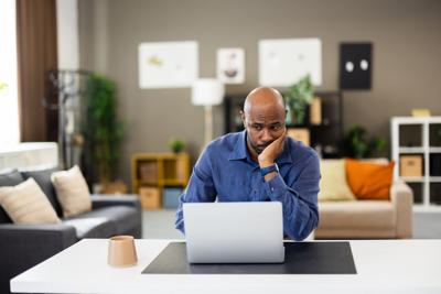 Man working on computer looking serious