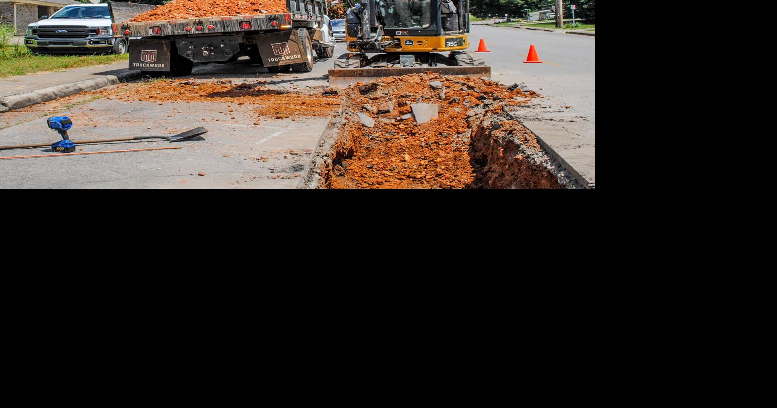 Workers repairing hole in street