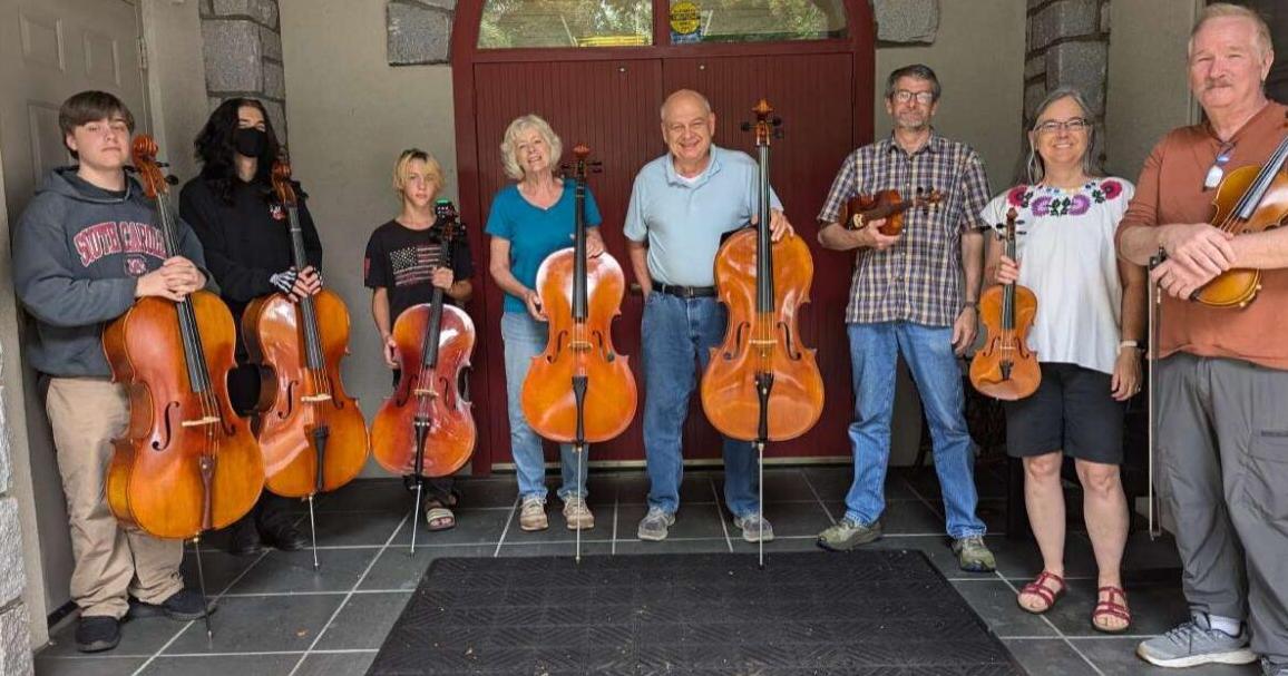 Adults and children collaborate to play music together