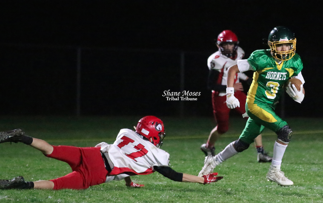 Inchelium’s Jeramy Phillips Jr., (#3 green) makes the catch and runs up field against Northport on Friday (Oct. 8) evening in NE 1B League action.