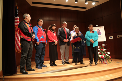 Mel Tonasket, Andy Joseph, Jr., Ricky Gabriel, Barp Aripa and Geri Gabriel stand with EWU President Mary Callinan and EWU Board of Trustees Chair Jim Murphy at stage at the Northwest Museum of Arts and Culture in Spokane, Nov. 24.