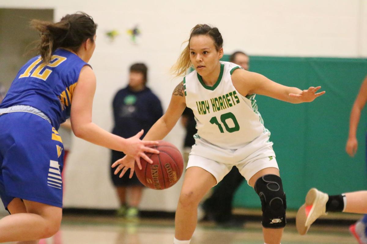 Colville tribal member Jaylene Lelone (No. 10 white) of Inchelium defends on the play against Wellpinit on Wednesday, Feb 7 in first round of the Northeast District 7 1B girls basketball tournament. Inchelium defeated Wellpinit 61-58.