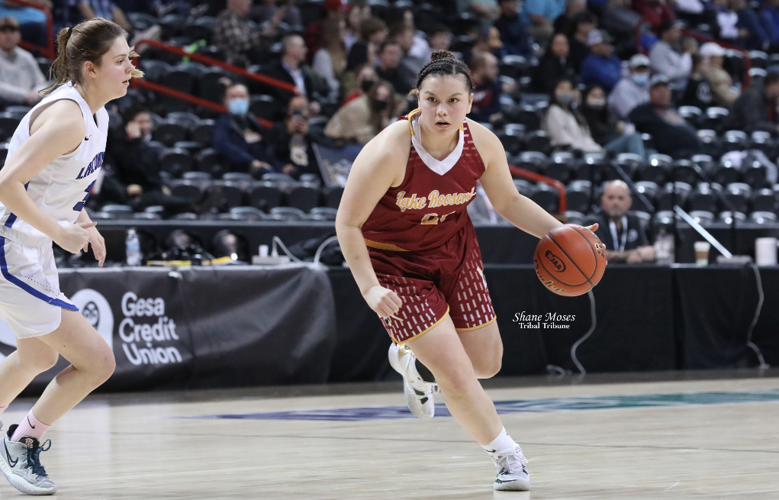 Colville tribal member Aaliyah Marchand (#21 maroon) of Lake Roosevelt dribbles to the hoop against La Conner on Friday (March 4) morning at this year’s WIAA 2B girls state tournament at the Spokane Arena.