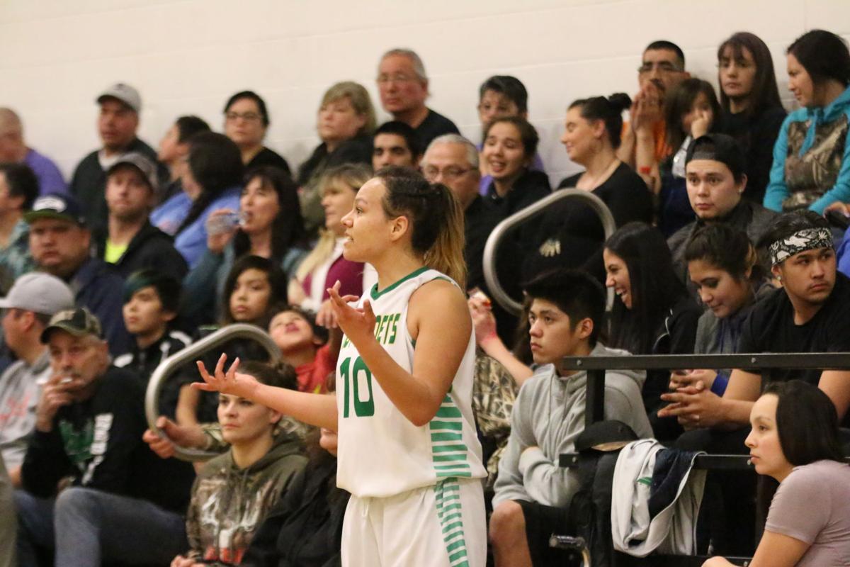 Colville tribal member Jaylene Lelone (No. 10 white) of Inchelium looks to the sidelines for the play against Wellpinit on Wednesday, Feb 7 in first round of the Northeast District 7 1B girls basketball tournament. Inchelium defeated Wellpinit 61-58.