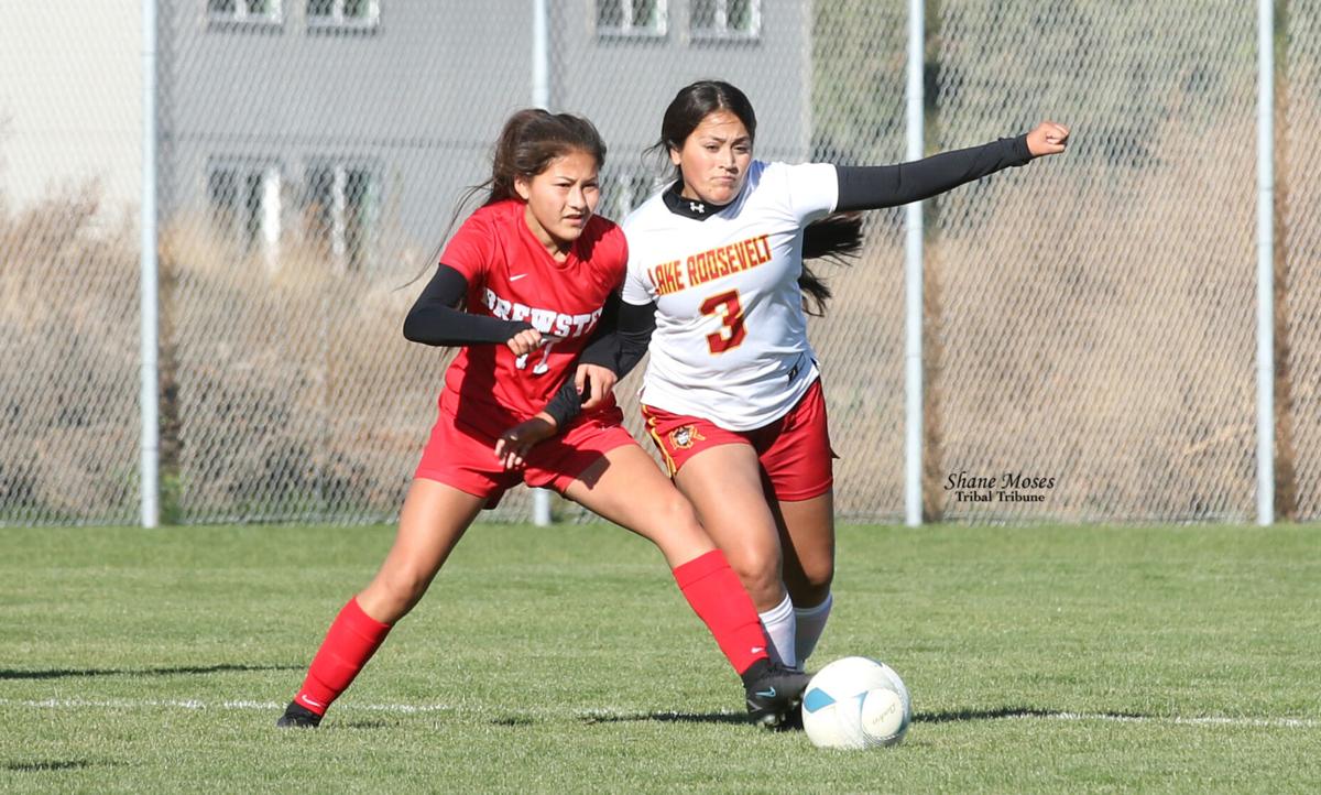 Colville tribal member Almeta Desautel (#3 white) of Lake Roosevelt fights for possession of the ball against Brewster on Saturday (Oct. 30) morning in the first round of the District 6 2B girls soccer tournament at Brewster High School.