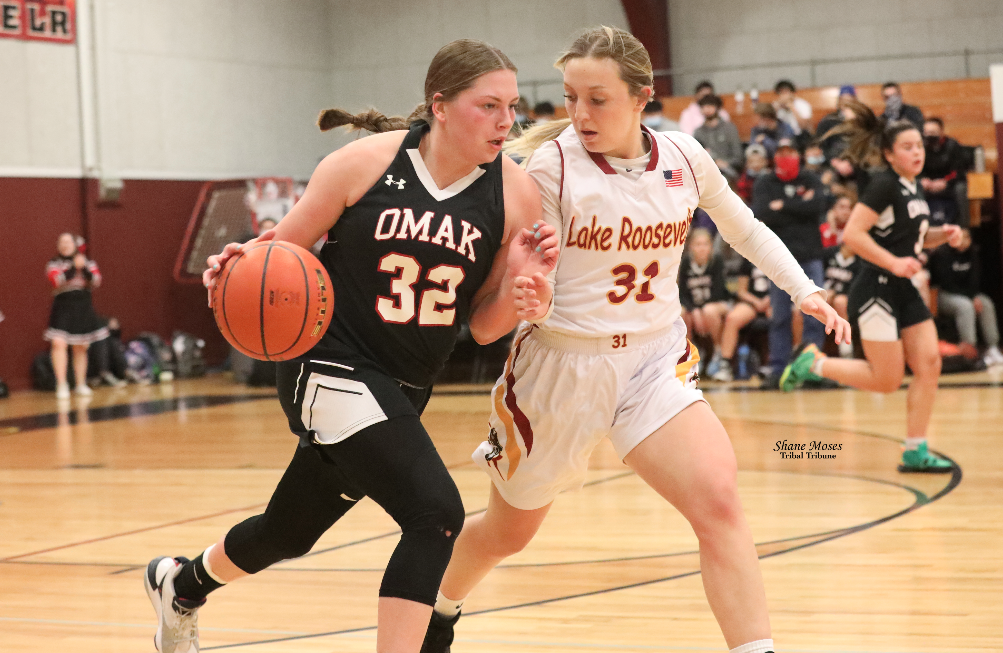 Omak’s Sedajeau Michel (#32 black) dribbles the ball up court against Lake Roosevelt’s Sawyer Steffens (#31 white) on Tuesday (Dec. 7) evening in non-league action.