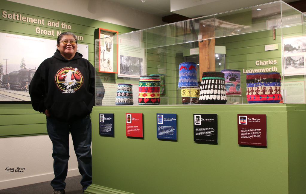 Colville Tribal elder and artist Julie Edwards stands next to her basket exhibit at the Greater Leavenworth Museum on Saturday (Dec. 4) morning.