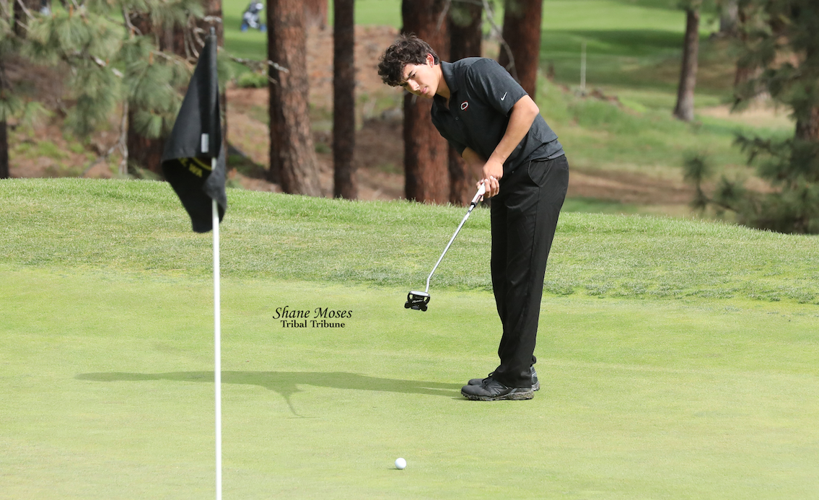Omak High School golfer Blake Sam (Colville tribal member) watches his putt shot near the No. 9 hole at Indian Canyon Golf Course in Spokane, Washington during Day 1 of the WIAA Class 1A boys state golf tournament on Tuesday morning, May 24, 2022.